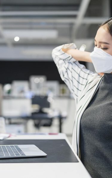 asian female office staff wearing faa mask hand touch body neck